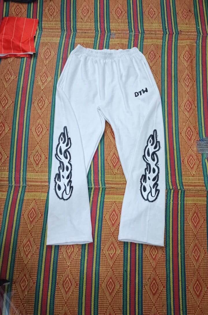 White DTW pants featuring stylish flame designs, perfect for comfortable everyday wear.
