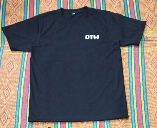 Black DTW T-shirts displayed on a colorful woven background, showcasing stylish and versatile everyday wear.