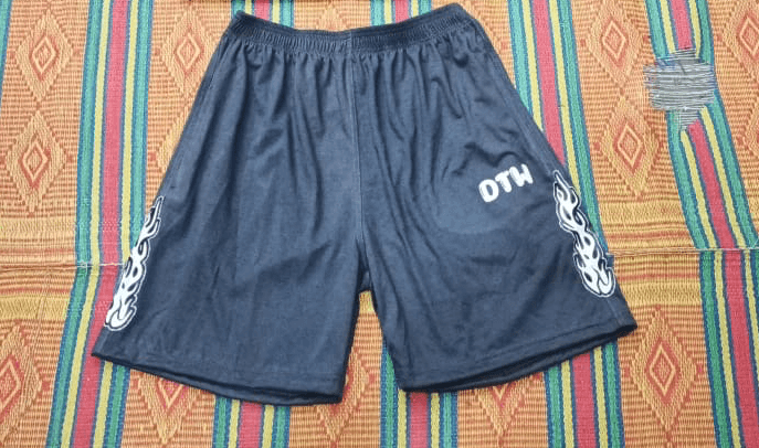 Gray DTW shorts on a colorful woven mat, designed for comfort and versatility in all occasions.