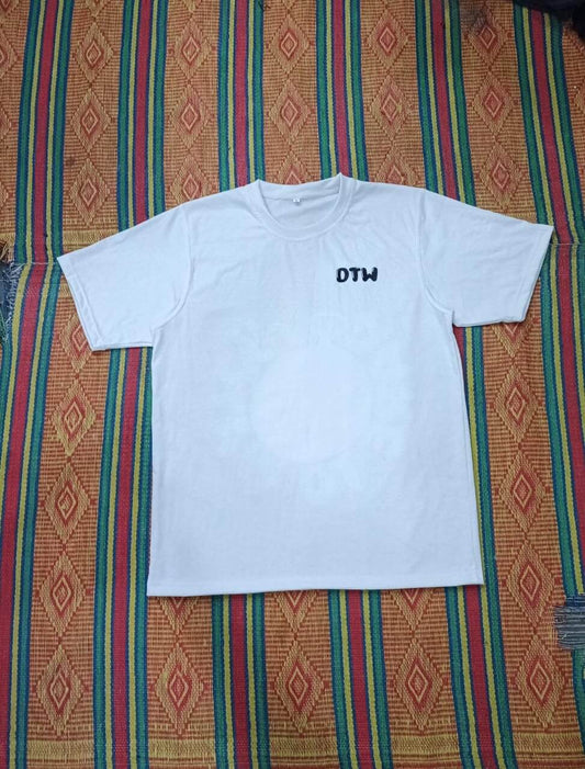 While DTW t-shirts displayed on a colorful patterned background, showcasing a comfortable white tee.