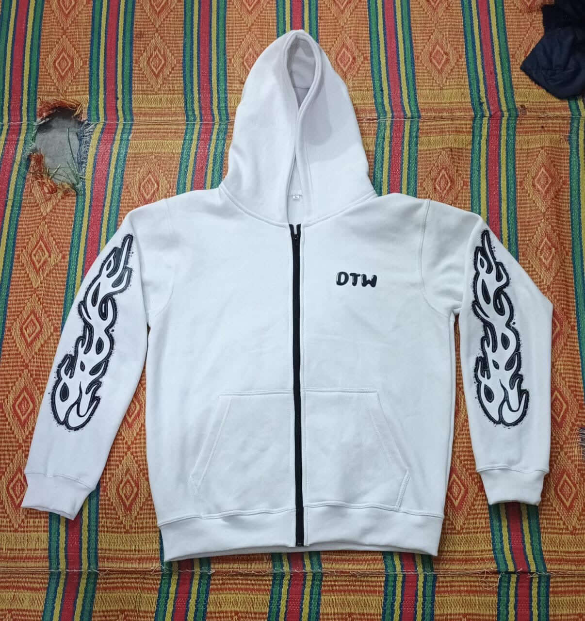 White DTW hoodies featuring stylish flame designs on the sleeves and a cozy hood for ultimate comfort.