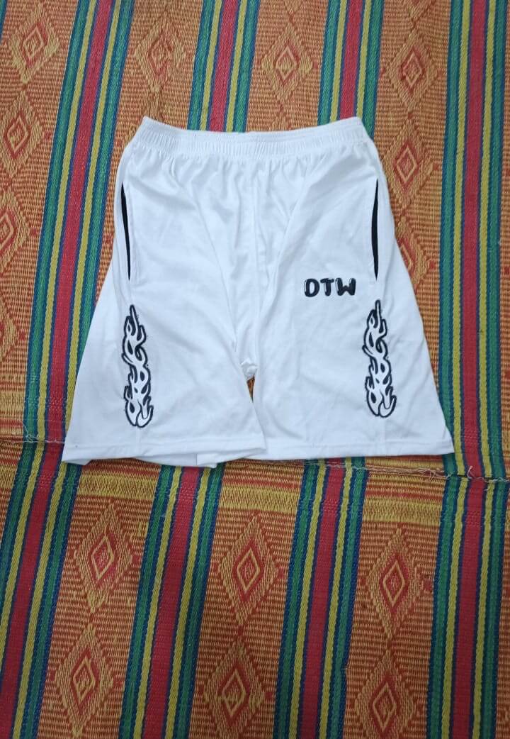 White DTW shorts featuring stylish flame designs, perfect for comfort and versatility in any occasion.